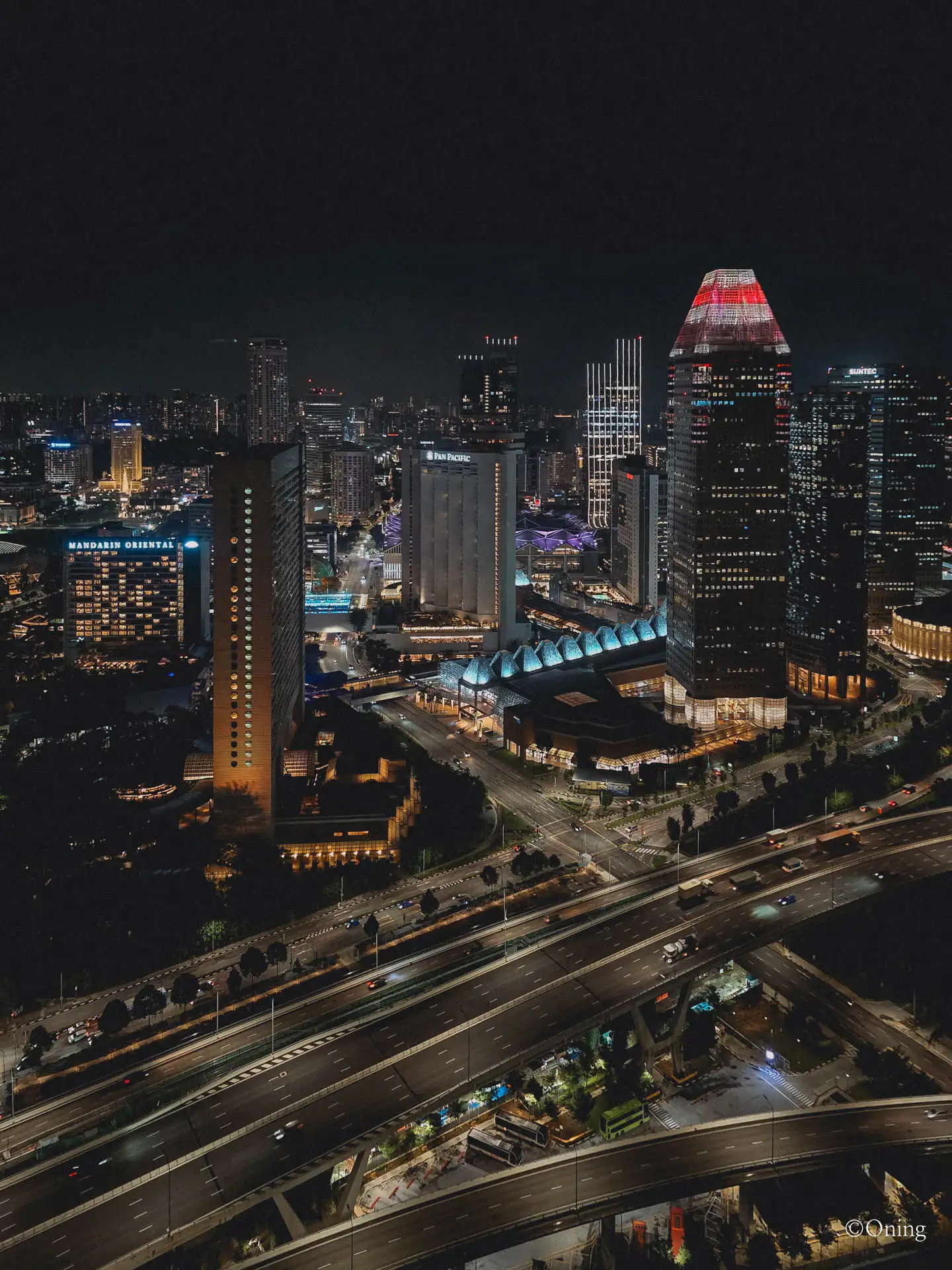 City Hall hotels at night from Singapore Flyer — Fairmont Singapore, Swissôtel, Mandarin Oriental, Pan Pacific