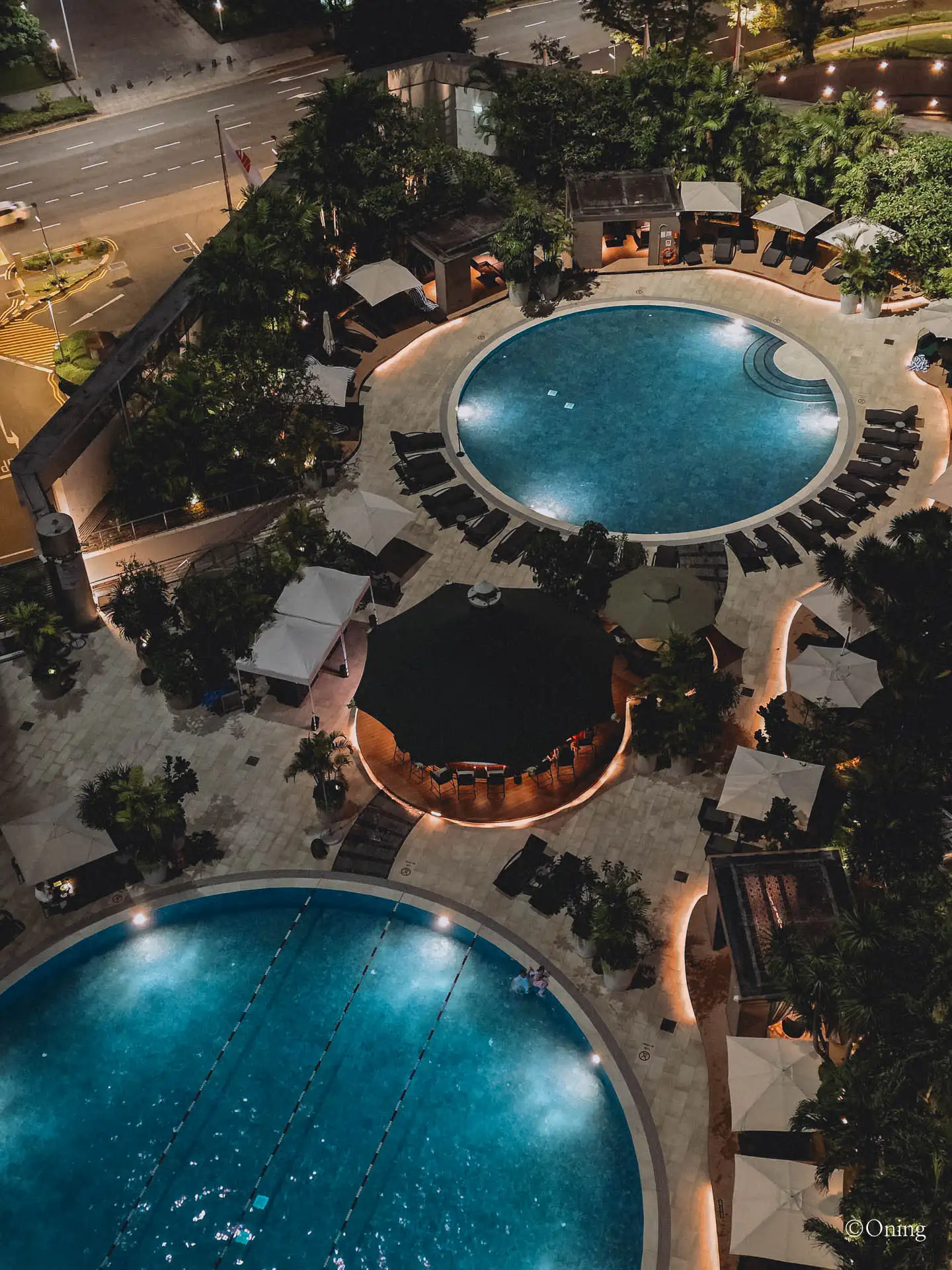 The shared pool deck between Fairmont Singapore and Swissôtel The Stamford, seen from balcony