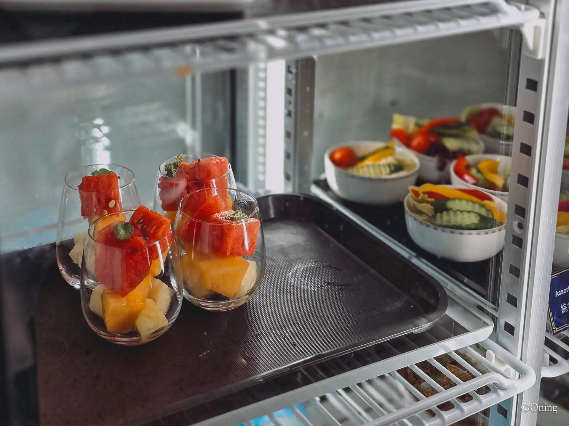 Close-up of fresh fruit cups with watermelon, melon and pineapple in the lounge
