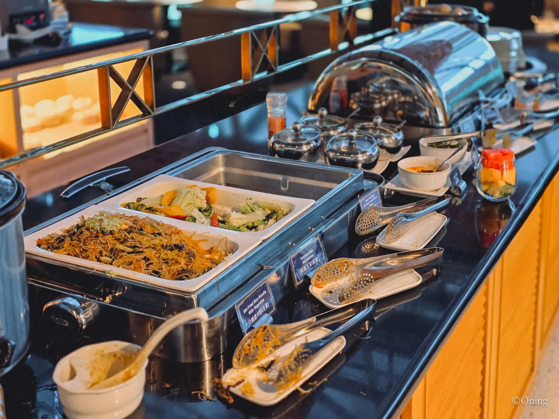 Hot buffet line with Taiwanese fried vermicelli and vegetables in chafing dishes