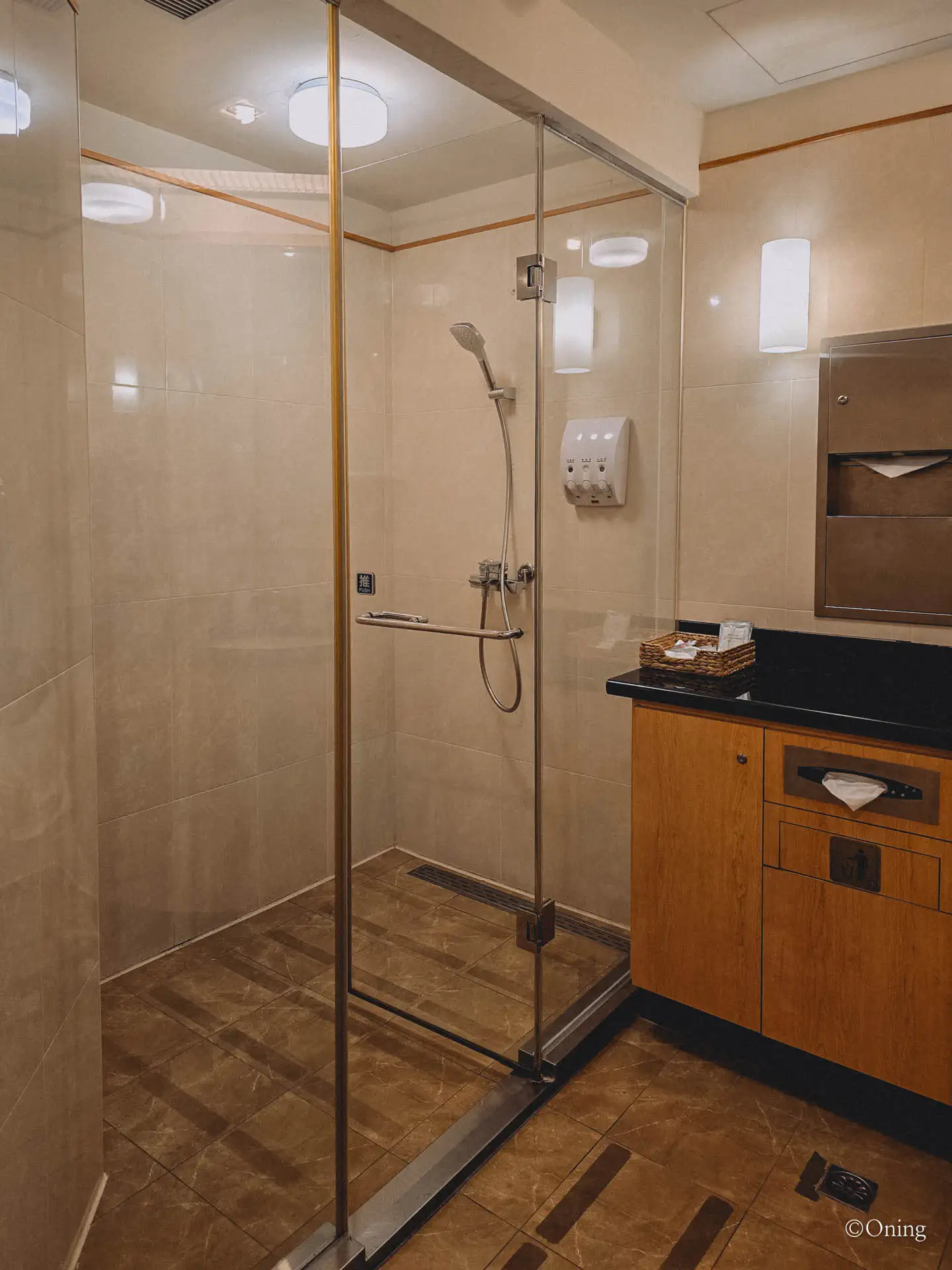 Clean glass-walled shower room at the SilverKris Lounge in Taoyuan Terminal 2