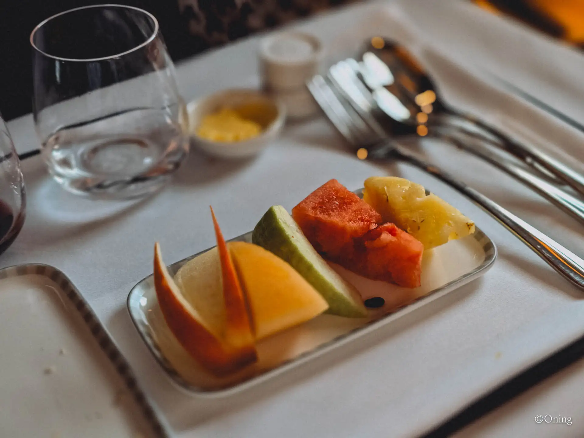 Fruit dessert plate with apple, melon, watermelon and pineapple on the flight