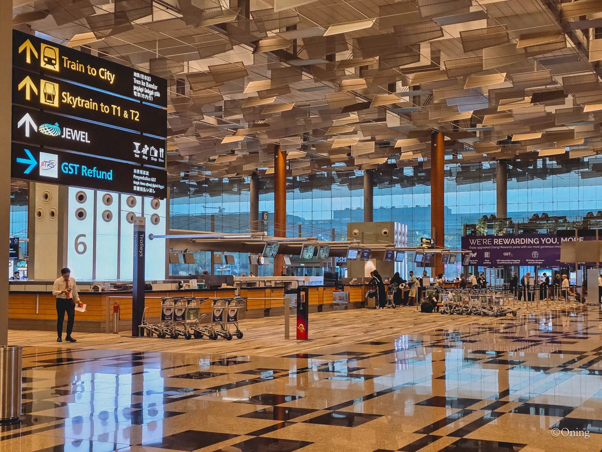 Directional signage at Changi Terminal 3 departures pointing to Jewel, the Skytrain and check-in