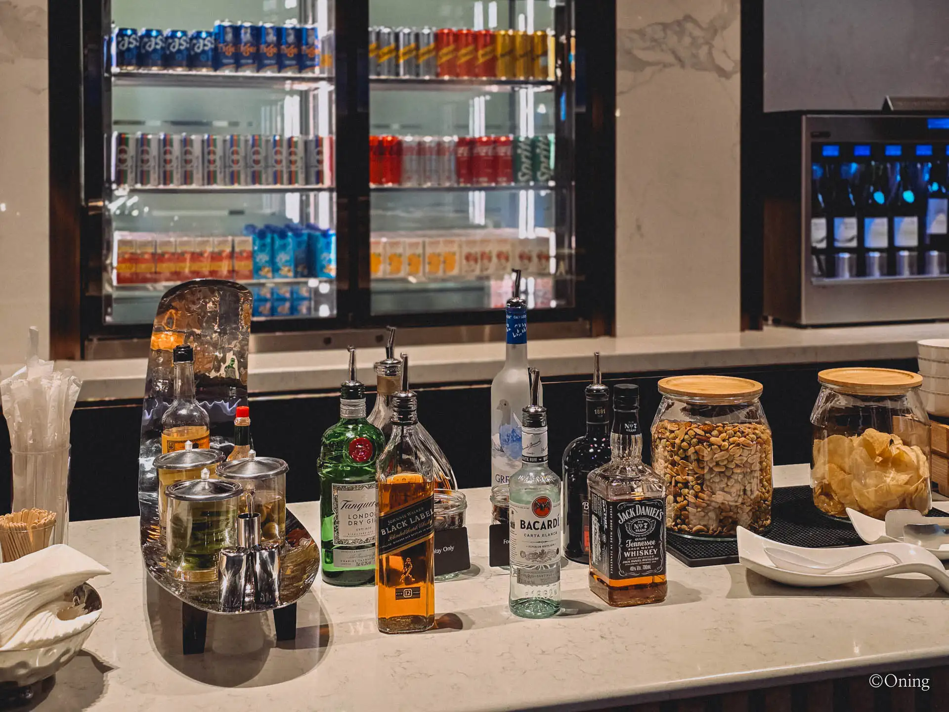 Self-serve bar with soft drinks, spirits and nuts at the Changi Terminal 3 SilverKris Lounge