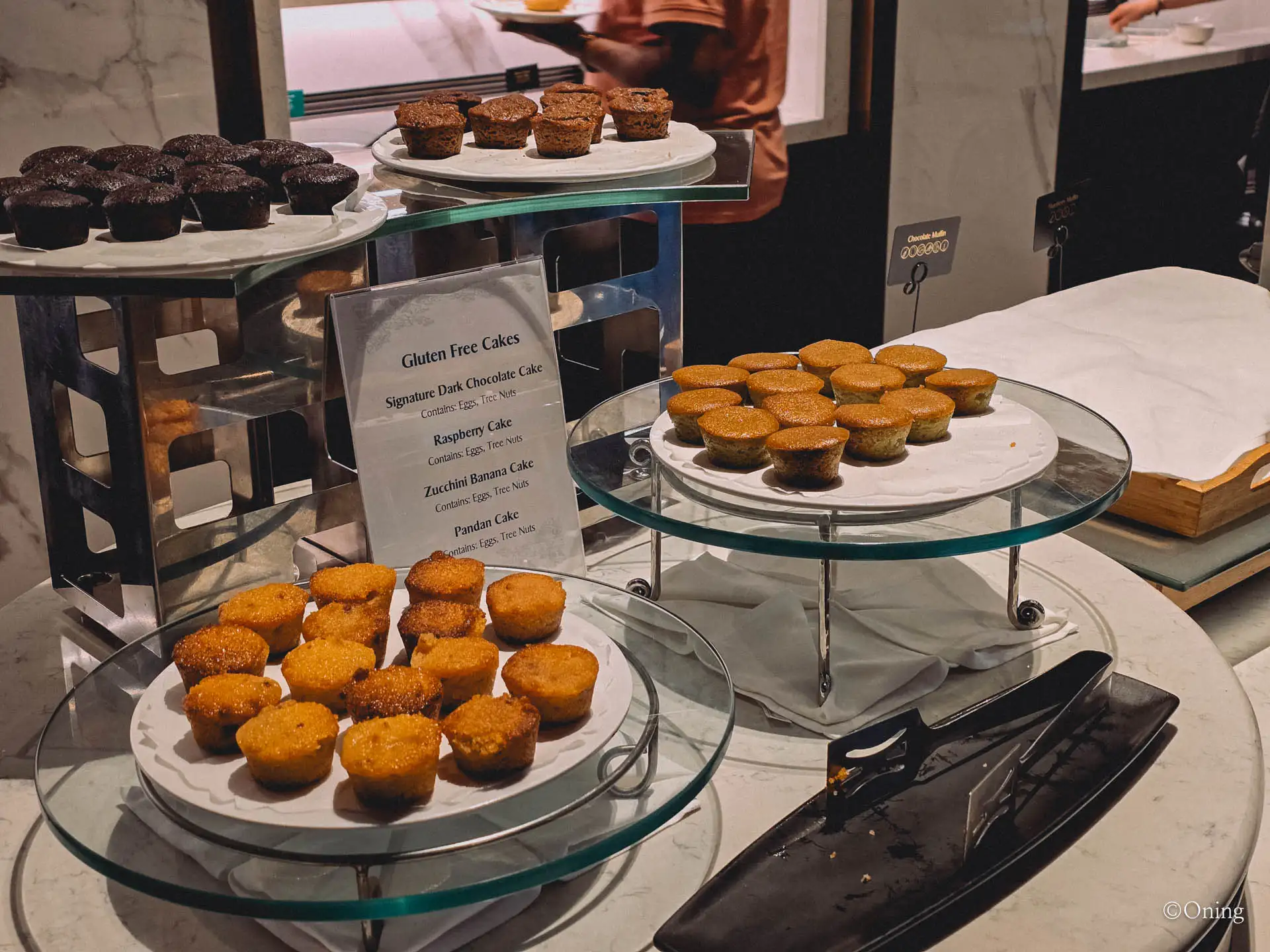 A display of gluten-free pandan and chocolate cakes at the lounge
