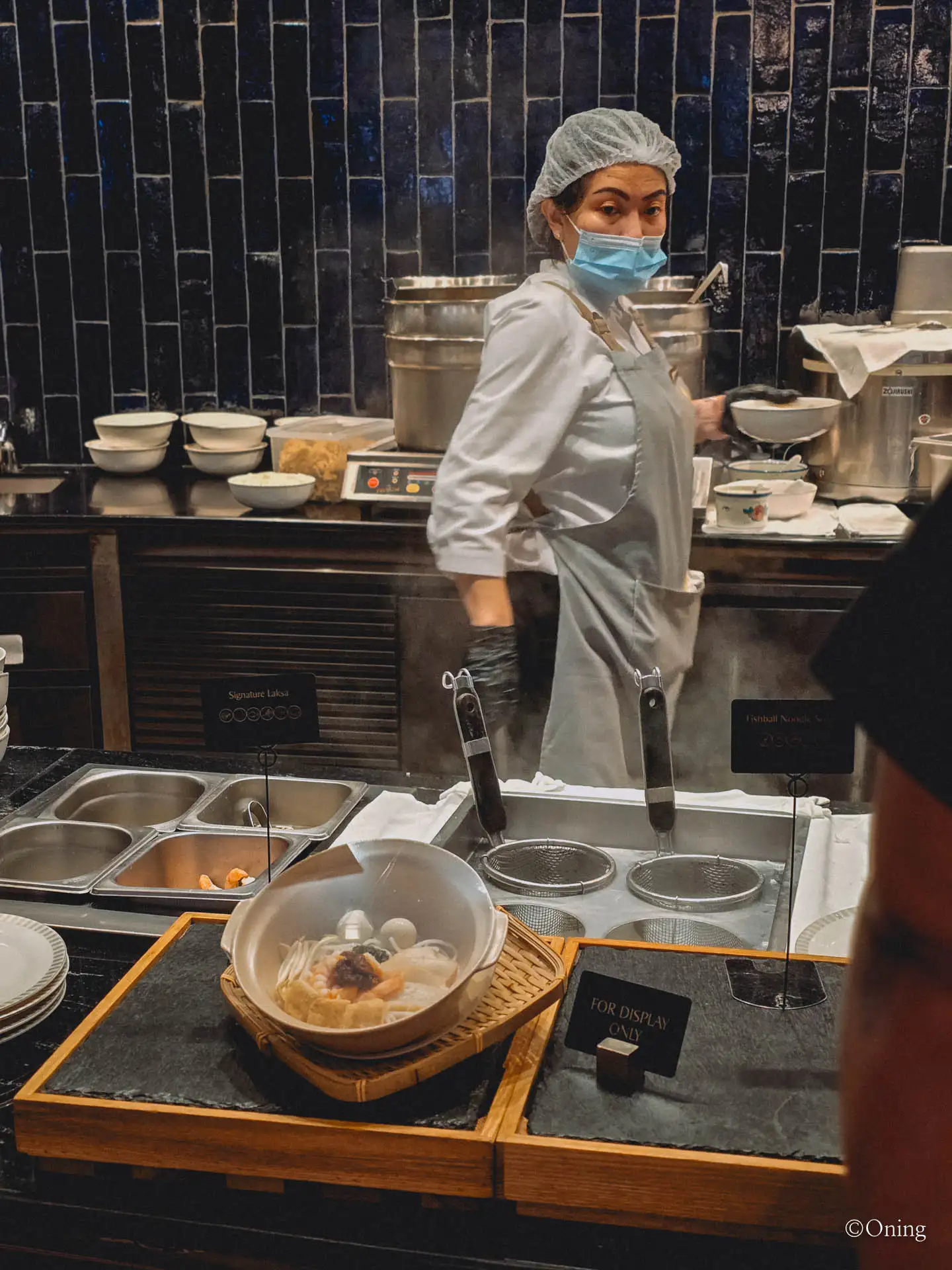 A chef preparing noodles at the live laksa station in the Changi Terminal 3 SilverKris Lounge