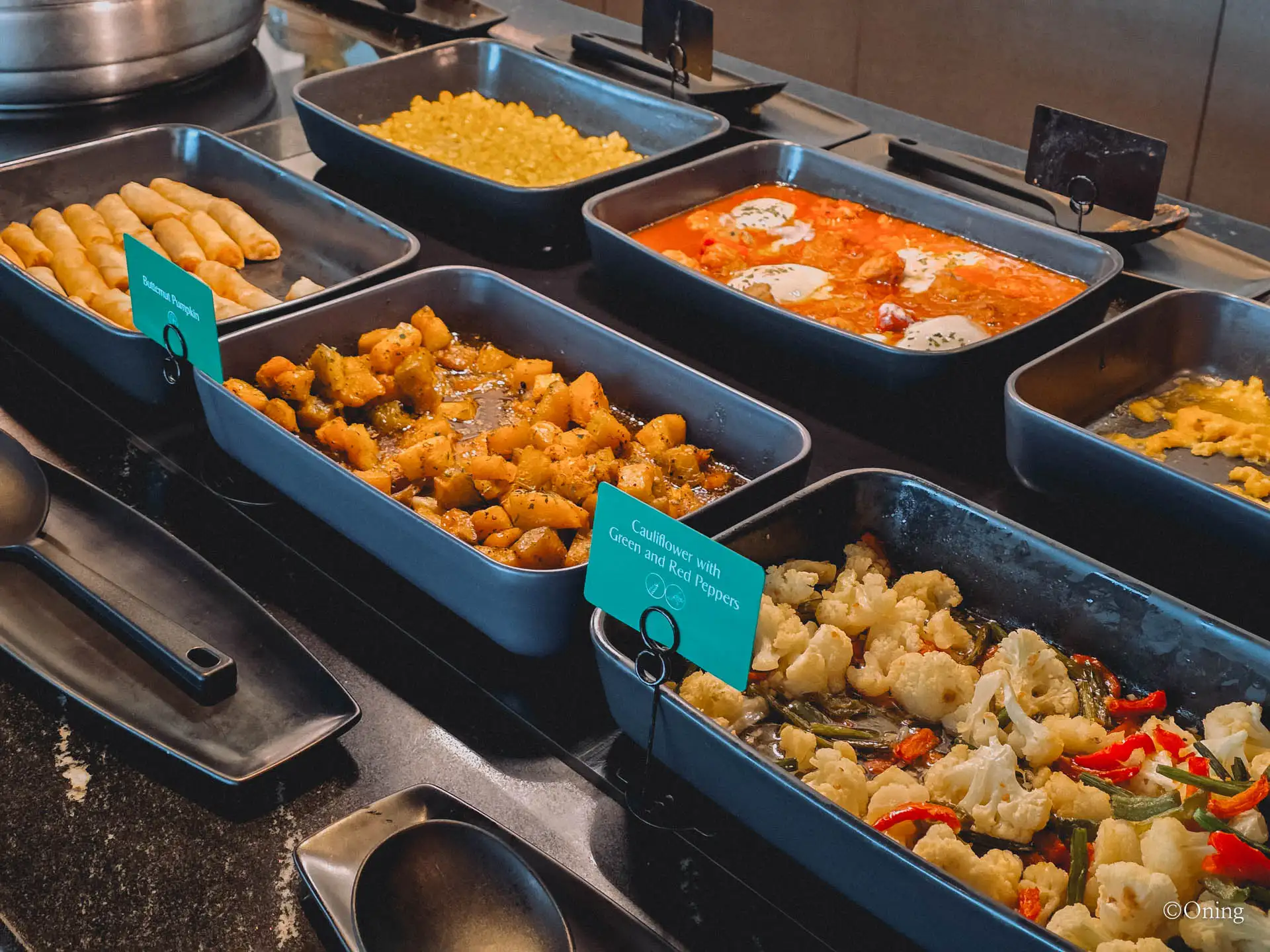 Hot breakfast trays of spring rolls, shakshuka and cauliflower at the lounge