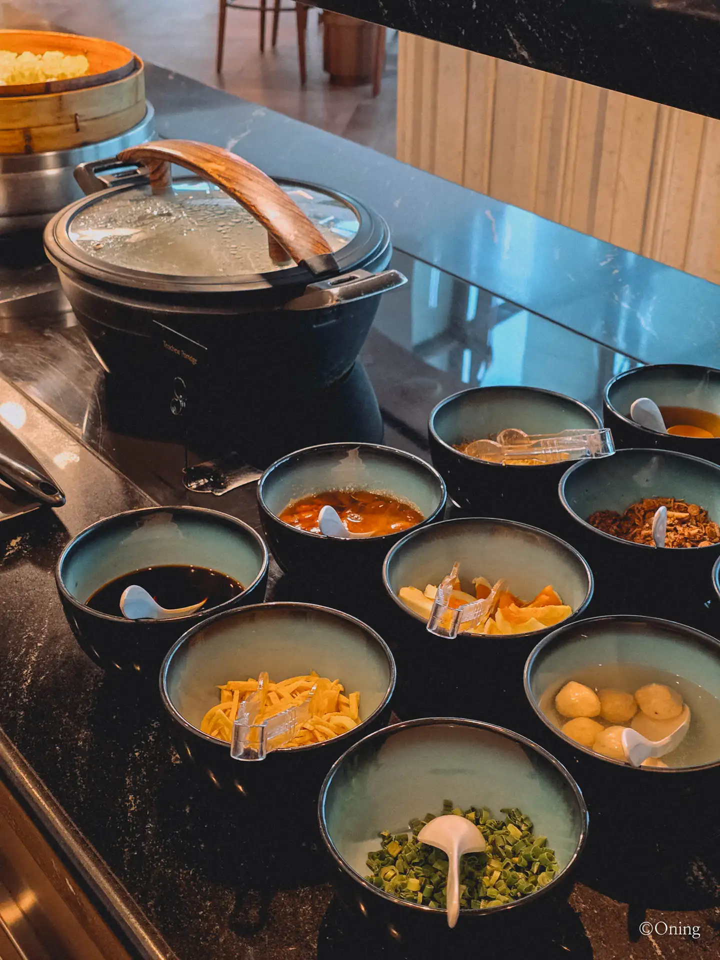 Bowls of congee toppings and condiments at the SilverKris Lounge